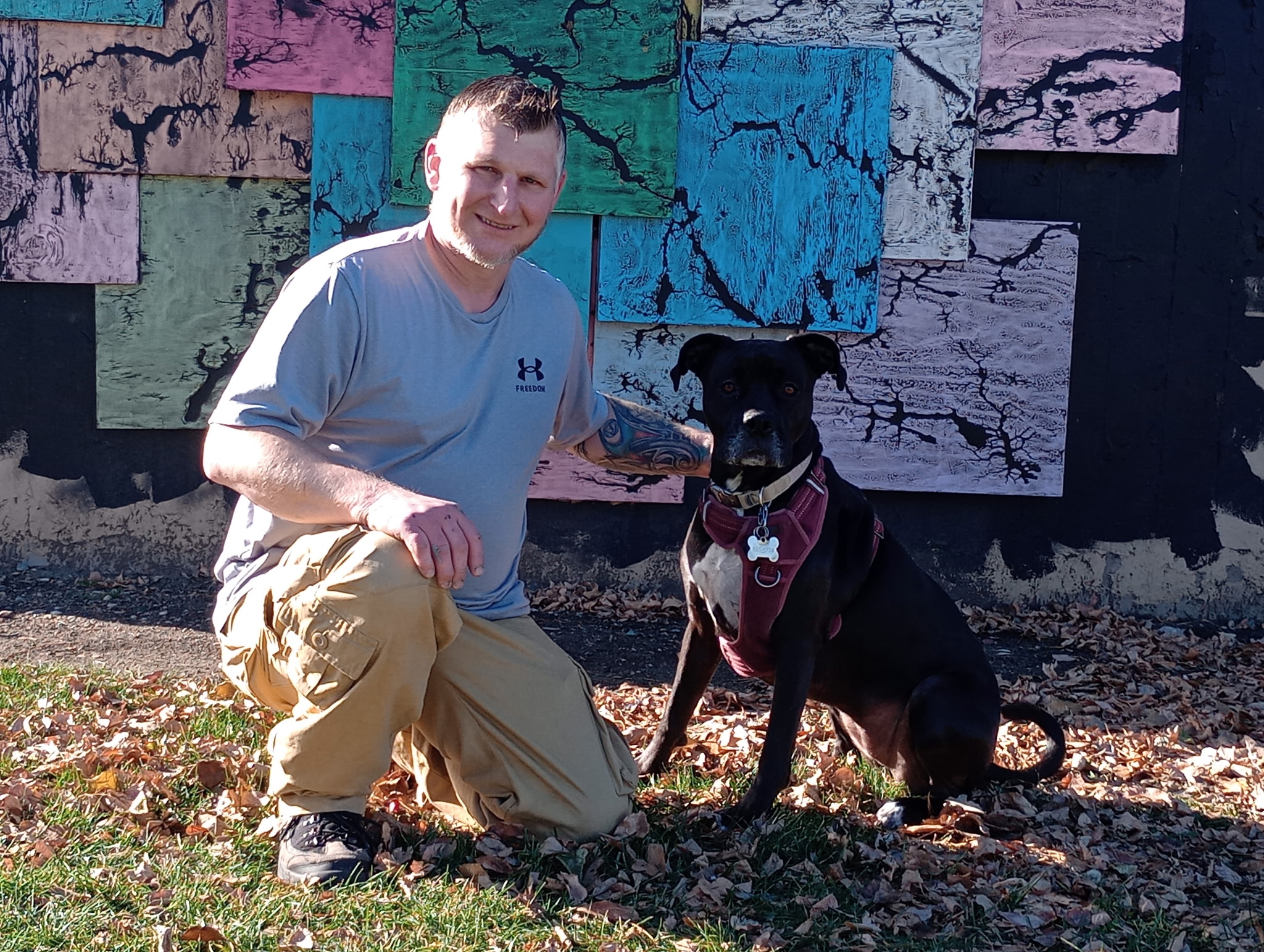 A closer portrait of Michael and Puppers in front of the puzzle